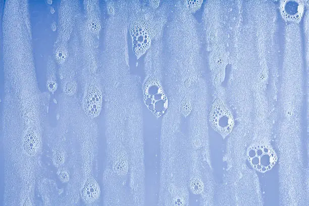 Photo of wet windows with soap bubbles background