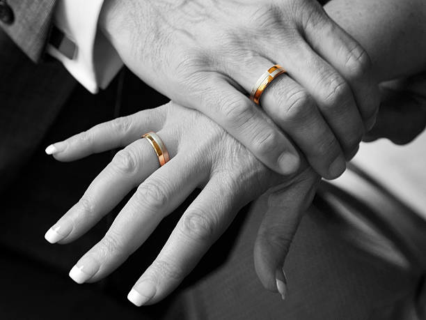 istock Black and White, Close-up - Hands with Golden wedding rings 155286927