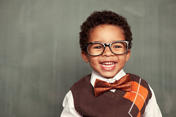 Happy Kid Nerd Portrait of a dapper and aspiring young nerd. It is never too early to be smart. bow tie photos stock pictures, royalty-free photos & images