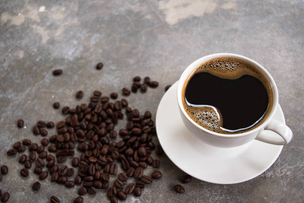 istock Black coffee in a white glass placed on an old cement table. 1552871240
