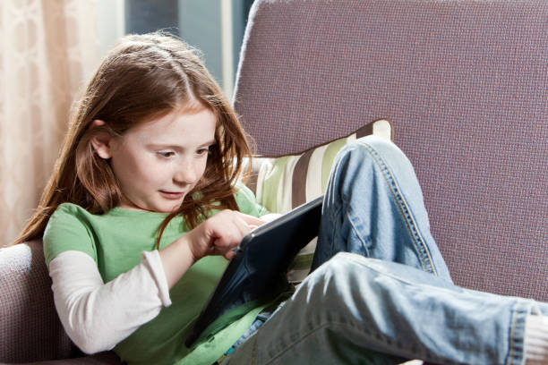 istock Little Girl Playing with Digital Tablet 155287370