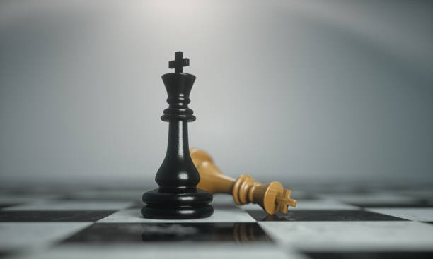 istock Illustration of chess pieces. Winning king standing beside fallen  king. 1552877188