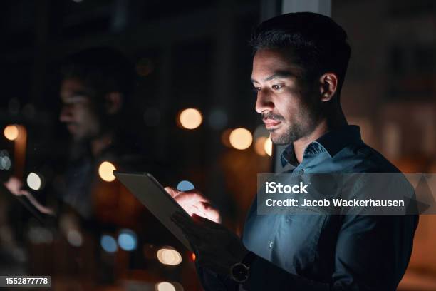 Night Work Or Man Reading On Tablet For Research Project Or Planning A Proposal In Office Building Startup Or Professional Employee Overtime Working Or Search On Internet Or Online Communication Stock Photo - Download Image Now
