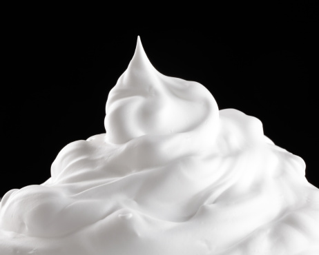 Whipped cream against a black background.