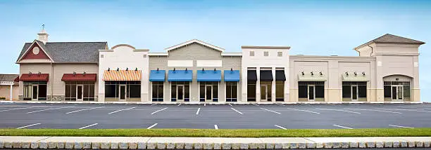 Photo of Modern Shopping Plaza Store Front Panoramic with Empty Parking Lot