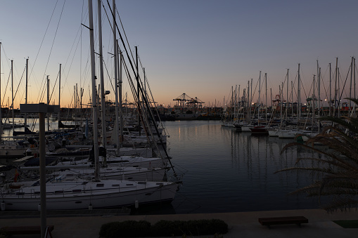 view of the industrial port at night - ships waiting for loading and unloading, cargo transportation by sea