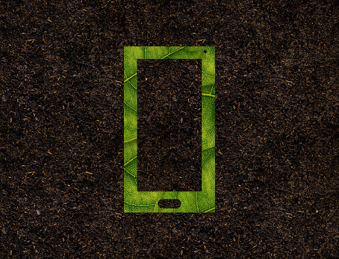 Smart Phone shape of green leaves on Soil background ecology concept