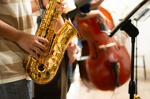 Close-up of a saxophone being played by a jazz band