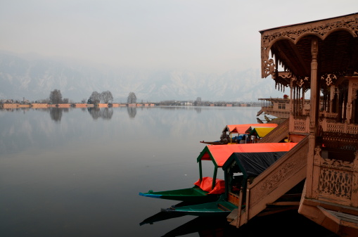 Dal lake is surrounded by mountains and beautiful snow. The Boat House is a tourist lodge was great to visit Kashmir, India