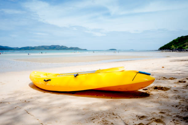 istock yellow boat on the beach. 1552895984