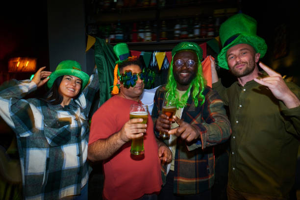istock Group of young intercultural friends in St Patrick attire looking at camera 1552895994