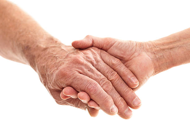 mani degli anziani - consoling close up senior adult grandparent foto e immagini stock