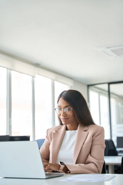 istock Professional business woman manager working on computer in office, vertical. 1552919160