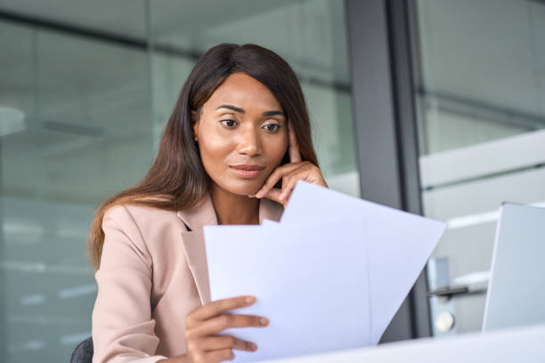 istock Busy business woman execuitve manager checking documents working in office. 1552919397
