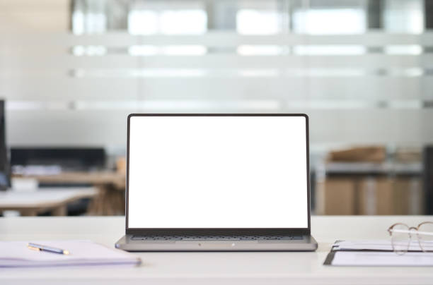 istock Laptop mock up template on office workplace desk, white mockup computer screen. 1552919424