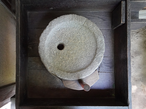 A traditional hand-turned millstone at Setagaya Ward Tsugidayubori Park (admission free) on a sunny day in June 2023 in Setagaya, Tokyo