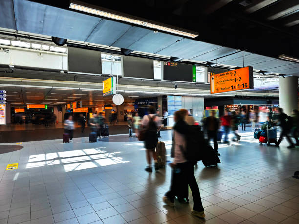 Airport Transfer In a hurry to catch next connecting flight or transit flight. Amsterdam Airport Schiphol hub with travelers in a rush priority baggage tag stock pictures, royalty-free photos & images