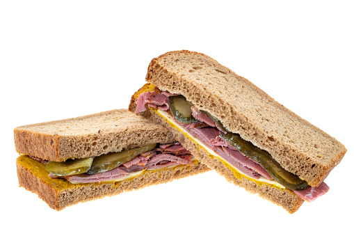 Salt Beef or Pastrami With Gherkins and cheese sandwich - white background