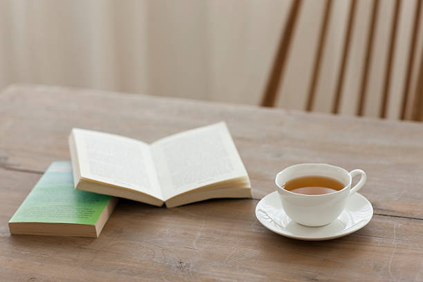 istock A single cup of tea on a wooden table with books 155294284