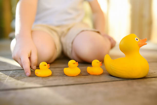 istock Preschooler child learns to count with toy ducklings 1552944846