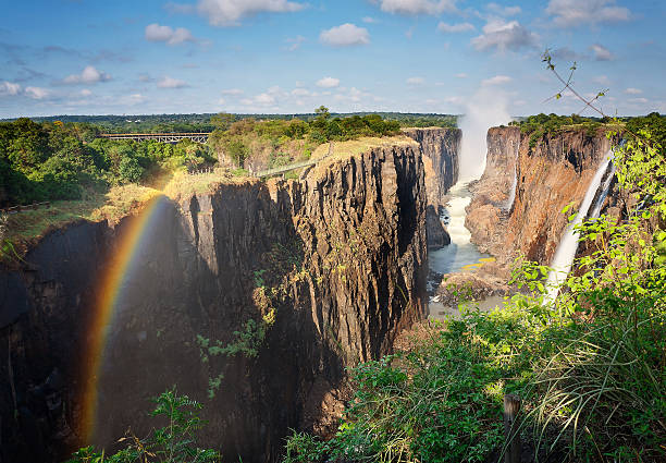 Victoria Falls, Zambia, and rainbow Victoria Falls, Zambia, with a rainbow landscape fog africa beauty in nature stock pictures, royalty-free photos & images