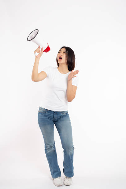 Asian woman smiling face holding megaphone shouting posing isolated on white background,