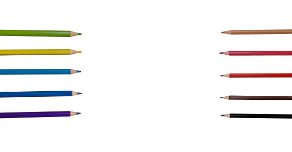 Colorful row of colored pencils isolated on a white background. Place to insert text, space between pencils