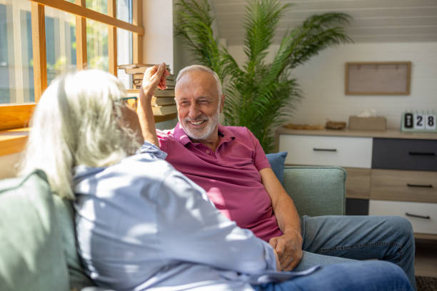 istock Senior couple talking and holding hands at home 1552978091