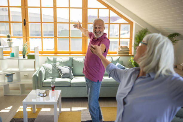istock Senior couple dancing in their living room 1552995453