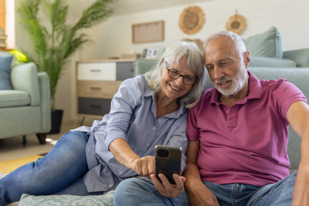 istock Senior couple using a smartphone at home 1553000193