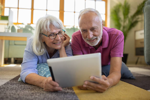 istock Senior couple using a digital tablet at home 1553000194
