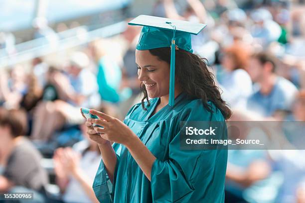 Female Graduate Using Smartphone Stock Photo - Download Image Now - Graduation, Middle Eastern Ethnicity, Education