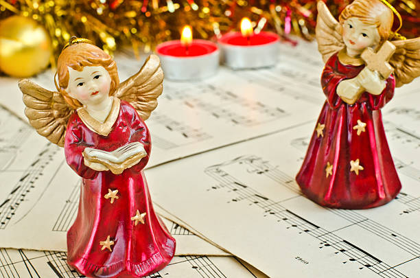 Christmas figurine of angels on a music sheet stock photo