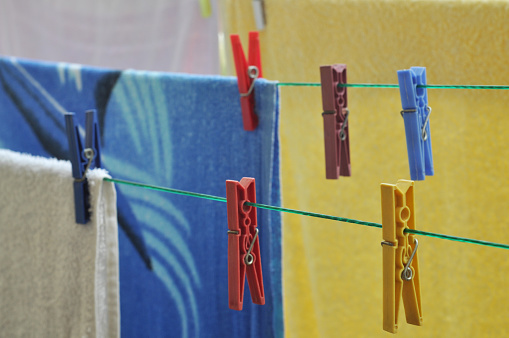 colorful clothes hanging with clothespins