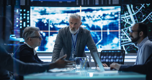 istock Diverse Group of Cybersecurity Experts Monitoring an Active Operation with Satellite Tracking Technology. Surveillance Office with Multiethnic Specialists Tracking a Target Vehicle in Urban Terrain 1553011605