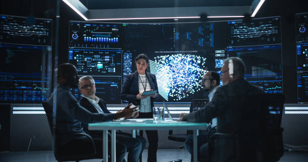 istock Chief Software Engineer Conducting a Quality Assessment Meeting With His Artificial Intelligence Design Team. Group of Developers Discussing Possible Development of a New Advanced Neural Network 1553012653