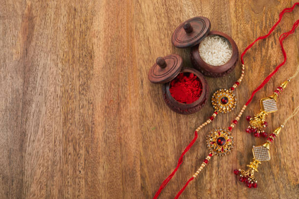 istock Raksha Bandhan background with Rakhi string, Rice Grains and Kumkum 1553013706