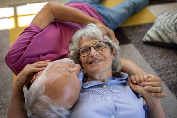istock Senior couple lying on the floor and talking 1553013809