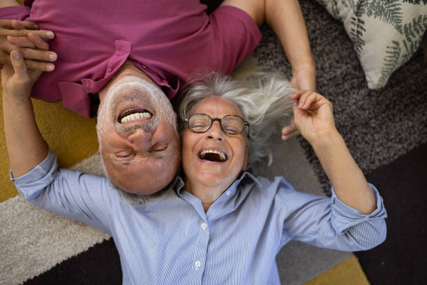 istock Senior couple lying on the floor and talking 1553013884
