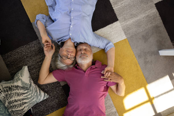istock Senior couple lying on the floor and talking 1553014224
