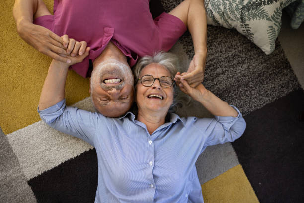 istock Senior couple lying on the floor and talking 1553014757