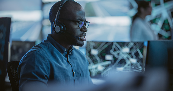 Black Multitasking Black Man Effectively Multitasking With Supporting Clients On A Phone ...