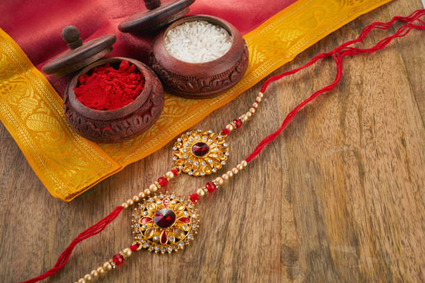 istock Raksha Bandhan background with Rakhi string, Rice Grains and Kumkum 1553027146