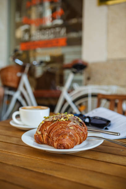 istock Morning coffee and croissant with reading material 1553043001