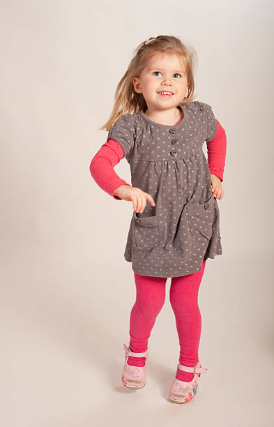 istock young girl happily jumping 155305165