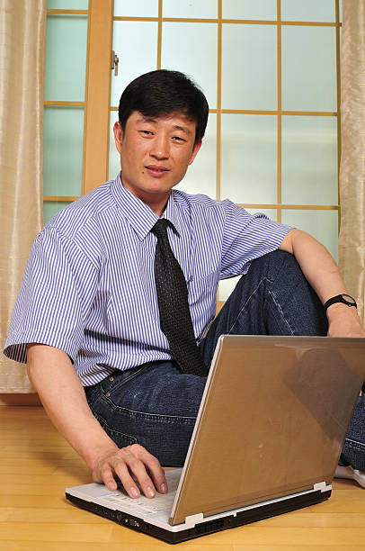 istock Happy young man working with laptop in the office 155305848