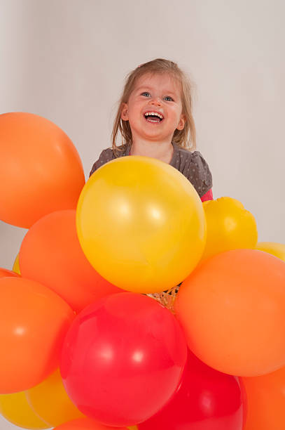 istock young girl playing with balloons 155306184