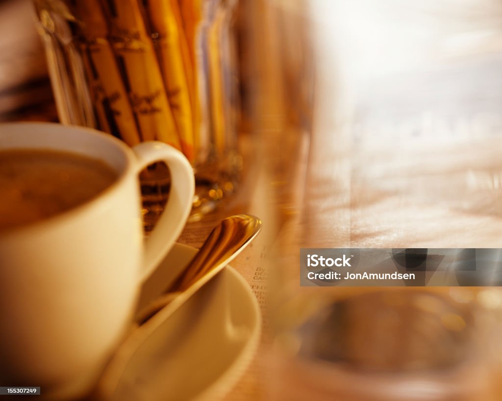 Coffee cup Time out at cafÃ©, reading the paper, enjoying a cappuccino and a glass of water.   After Work Stock Photo