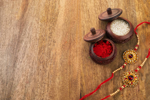 istock Raksha Bandhan background with Rakhi string, Rice Grains and Kumkum 1553073667