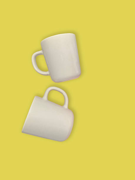 istock white cups on yellow background, mockup. Empty cups on color background 1553079170